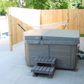 The new patio with hot tub and hammock.  New concrete, new fence, new porch light (upper right).