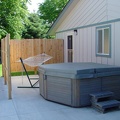 The new patio with hot tub and hammock.  New concrete, new fence, new door and screen door, new porch light.